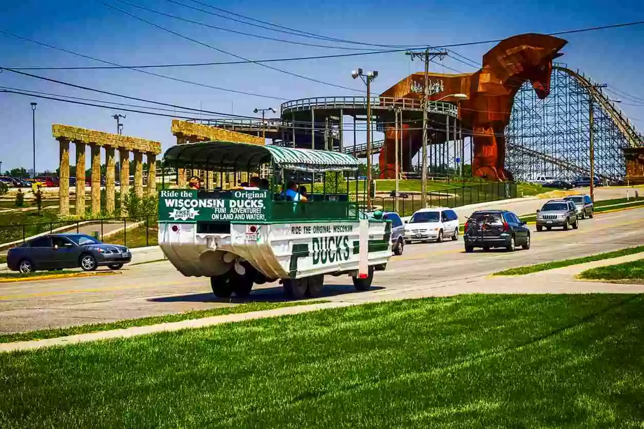 An open-air bus that reads "ducks" driving through Wisconsin Dells